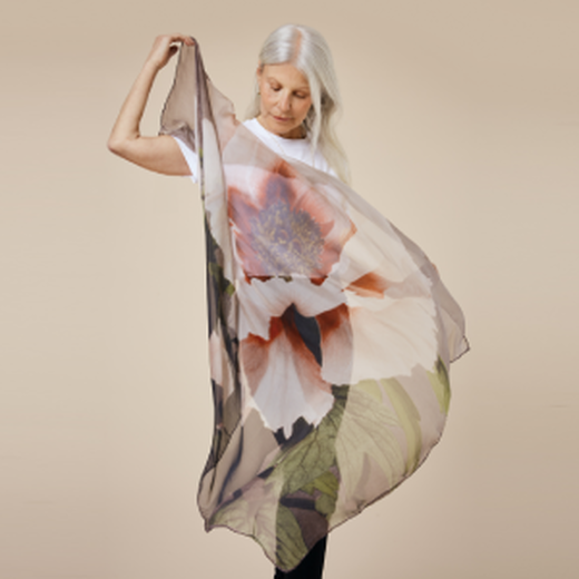 A model drapes the scarf to show the transparency and movement in the fine silk